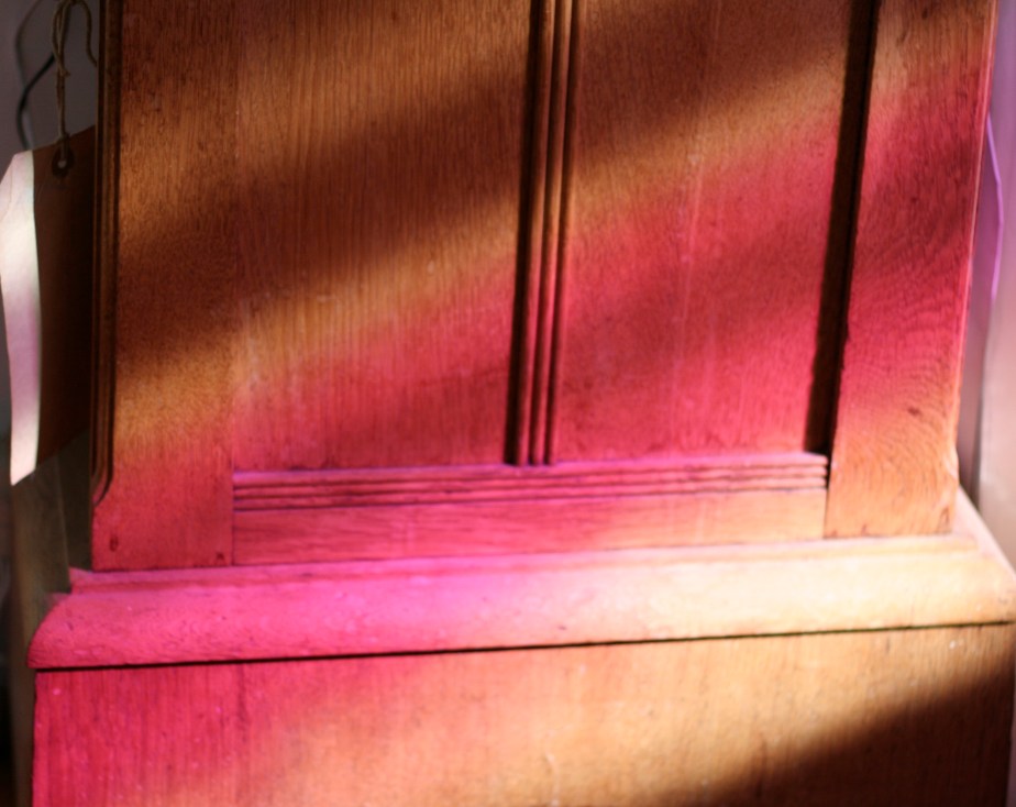 Pink light on oak clock