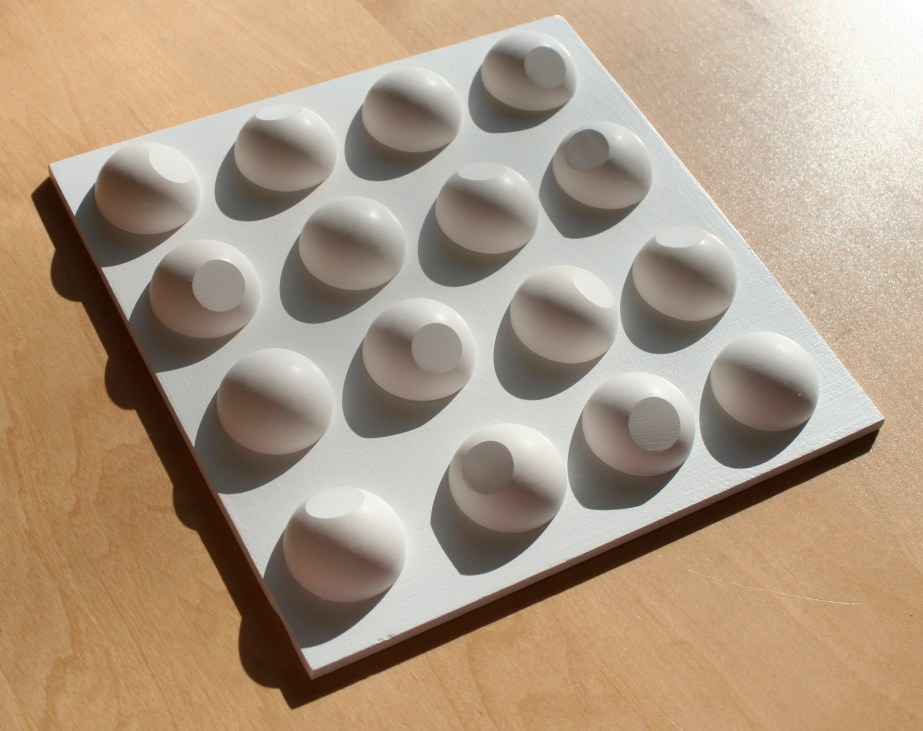 Shadows on geometric plaster cast sculpture