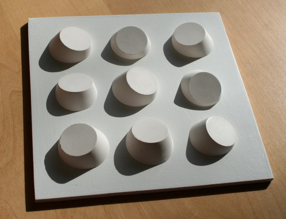 Shadows on geometric plaster cast sculpture