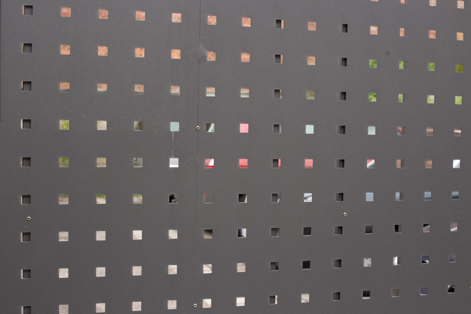 Cars seen through steel gate