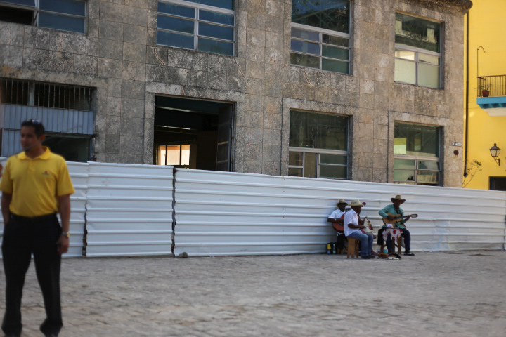 There is music playing everywhere, even outside this long-abandoned building supposedly being re-constructed.