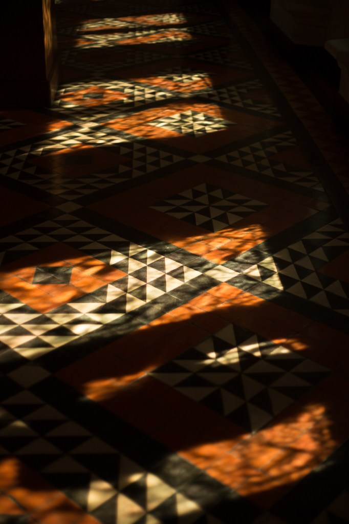 Sunlight and shadow on an intricate tiled floor in the house of Jacques Couer in Bourré